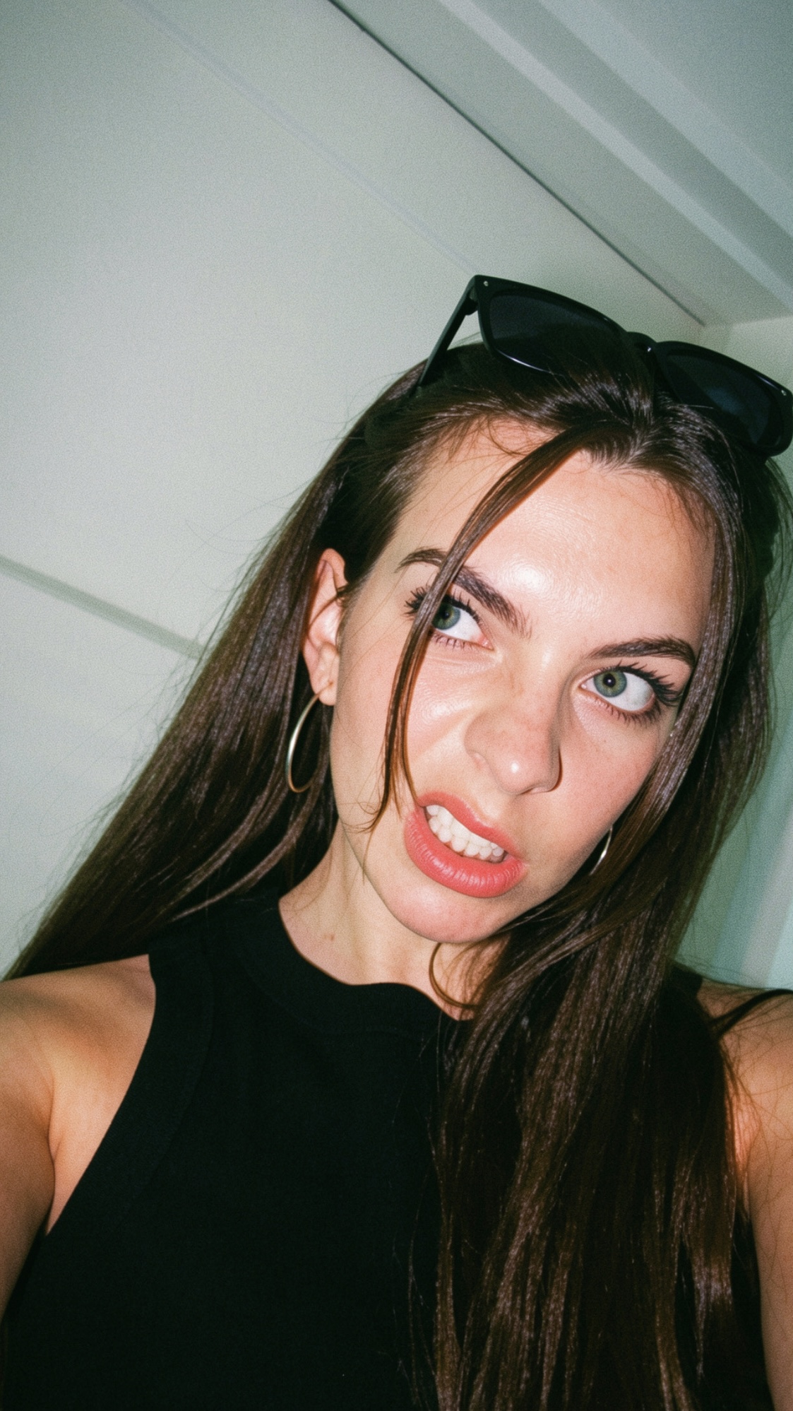 Hannah Fisher wearing sunglasses on her head and a black top